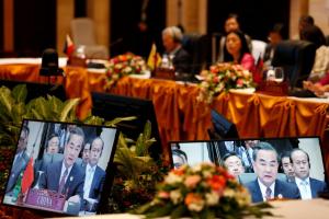 China's Foreign Minister Wang Yi is seen on screens while speaks during a meeting with ASEAN foreign ministers in Vientiane, Laos July 25, 2016. REUTERS/Jorge Silva